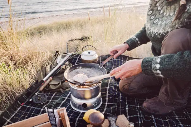 Photo of Fisherman cooking her catch at the beach