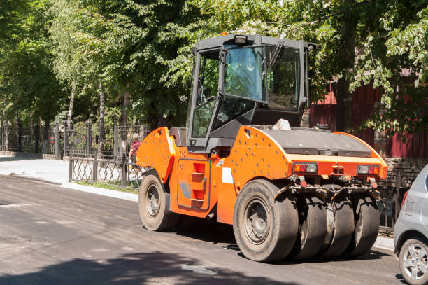 istock machine for laying asphalt, in the city during repair work 1073249792
