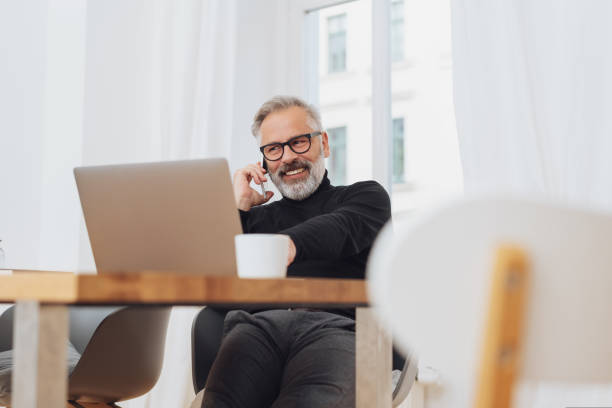 istock Businessman smiling as he talks on his mobile 1073253564