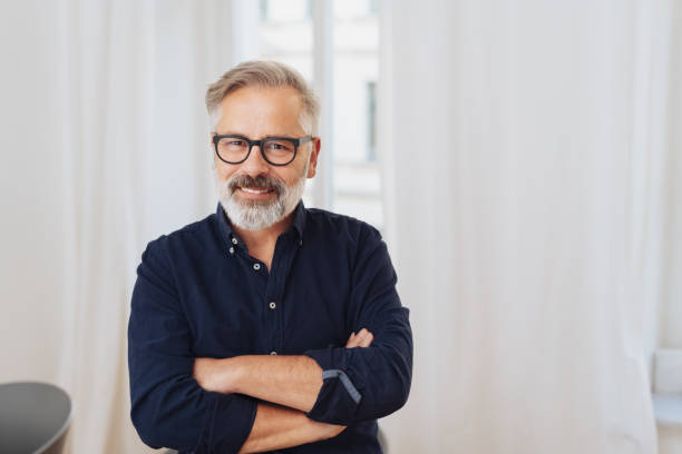 istock Middle-aged smiling man with arms crossed 1073254204