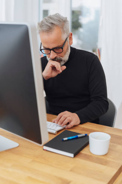 istock Thoughtful businessman staring at his keyboard 1073254636