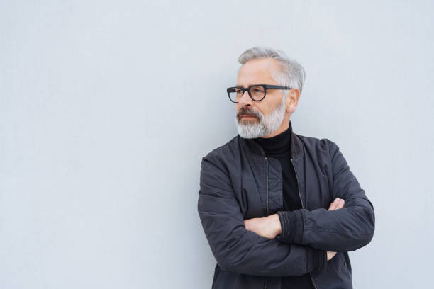 istock Senior man standing waiting with folded arms 1073257692