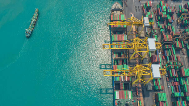 istock Container ship in export and import business and logistics. Shipping cargo to harbor by crane. Water transport International. Aerial view and top view. 1073257806
