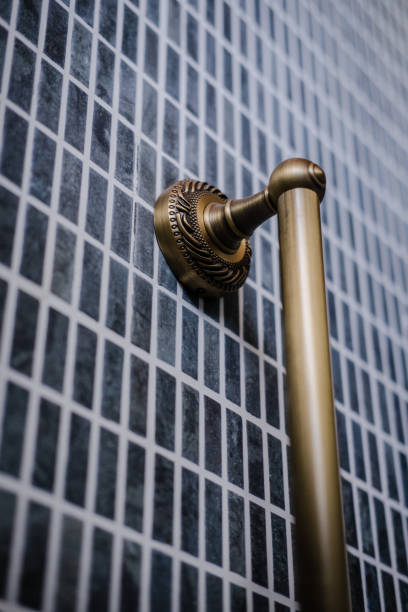 istock Unlacquered brass rail, dark bathroom design 1073259040