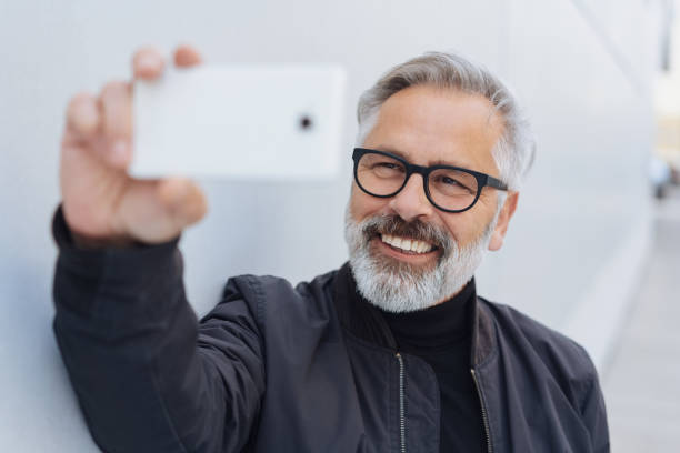 istock happy man posing for a selfie on his mobile 1073259546