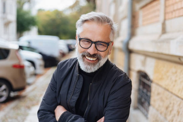 istock Attractive bearded man leaning forwards laughing 1073260188