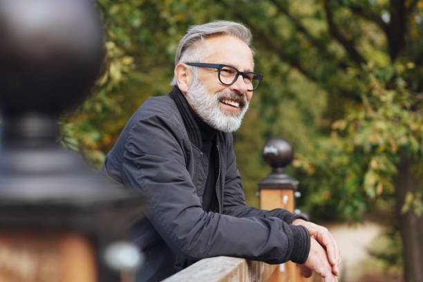 istock Happy bearded middle-aged man leaning on a parapet 1073262420