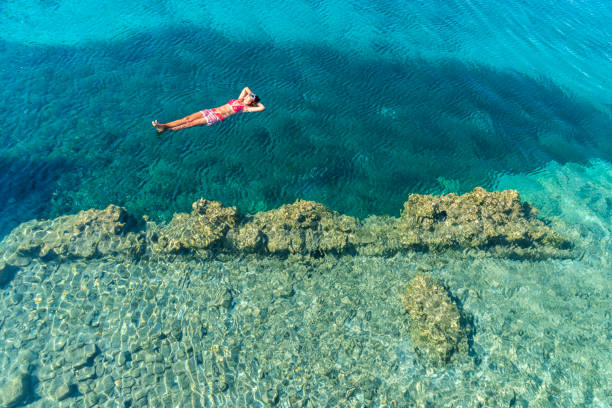 istock Woman is lying on the sea bed. 1073266436