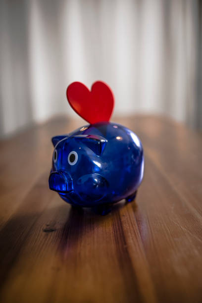 istock Piggy Bank on Wooden Table 1073267800