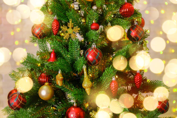 istock Christmas spirit concept. Pine tre with decorations on festive bokeh background. 1073280416