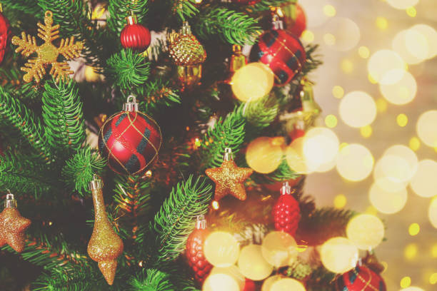 istock Christmas spirit concept. Pine tre with decorations on festive bokeh background. 1073280430
