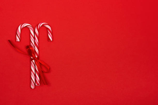 istock Christmas candy canes on red background. 1073283646