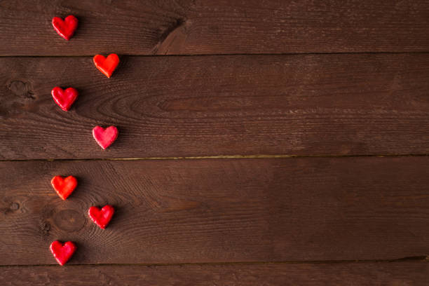 istock small hearts on a wooden background. Valentine's day concept. 1073289148