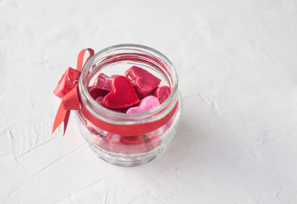 istock Valentine's day concept. jar with small hearts red and pink on a light background. 1073289354