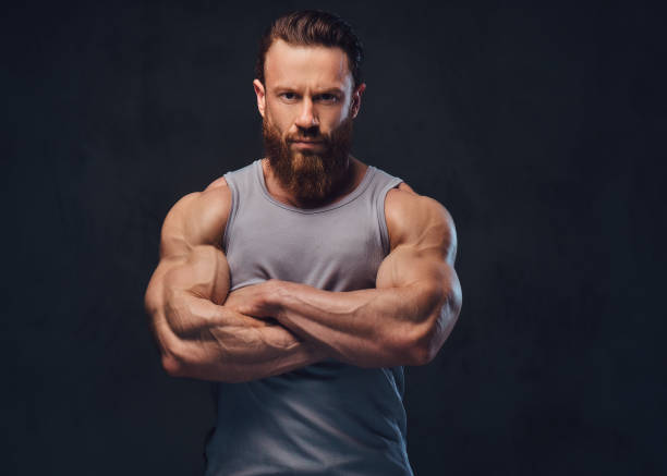 Bearded bodybuilder dressed in a tank top. stock photo