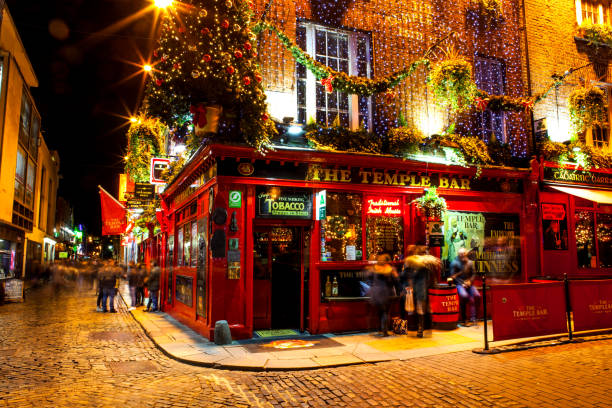 People around the famous red pub in the Temple Bar district in Dublin during the Christmas season Dublin, Ireland - November 15, 2018: People around the famous red pub in the Temple Bar district in Dublin during the Christmas season guinness photos stock pictures, royalty-free photos & images
