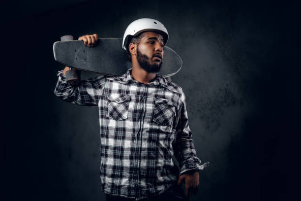 istock A man holds long board over grey background in a studio. 1073297226