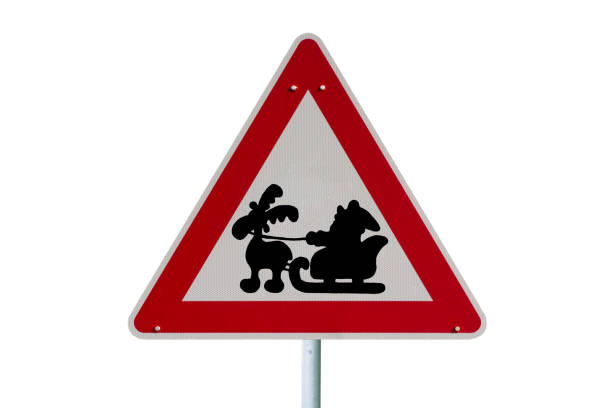 road sign in the snow with Santa Clause on a sleigh and reindeer isolated against a white background