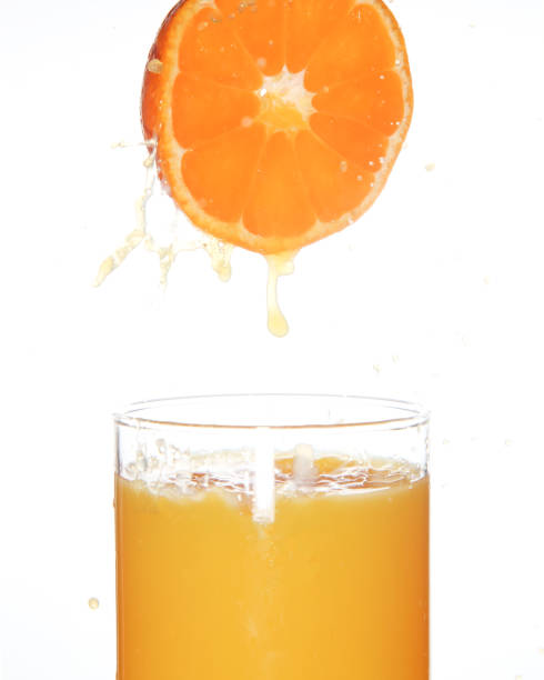 istock Orange juice in a white background 1073308410