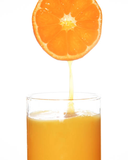 istock Orange juice in a white background 1073308414