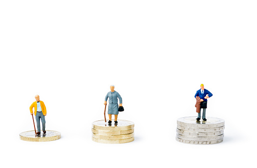 Small figurines and stacks of Euro coins on bright background. Inequality, poverty, earnings and income concept.