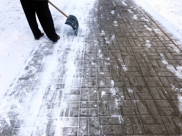 istock Worker sweep snow from road in winter 1073317308