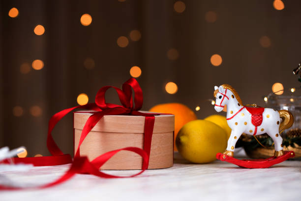 istock Christmas holidays composition  with copy space for your text. Christmas gift box in craft paper with red ribbon. round gift box with red ribbon 1073323468