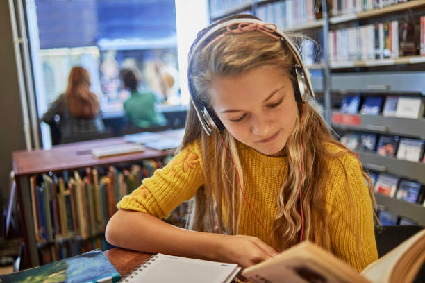 little girl listening to music and studying - child thinking writing little girls imagens e fotografias de stock