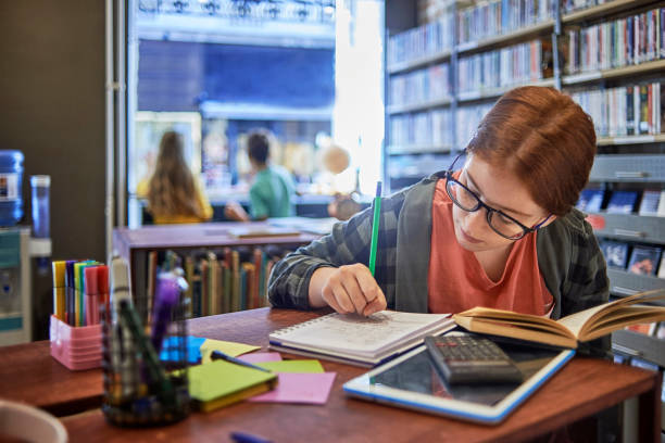 boring homework pictures young student studying in the library schoolgirl doing her homework boring homework twelve stock pictures, royalty-free photos & images
