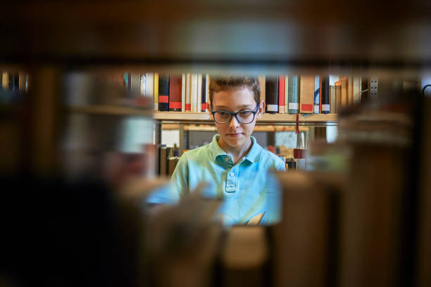 istock young school boy searching for a book 1073346692