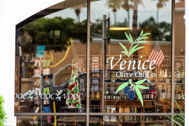 sign in small florida retirement city, town, or village, in gulf of mexico on street for olive oil business - venice italy italy street italian culture imagens e fotografias de stock