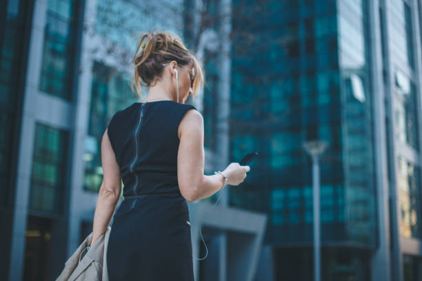 Businesswoman listening to a podcast while going to work