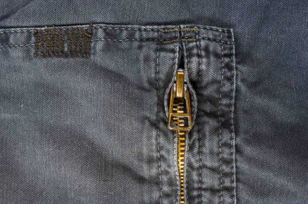 istock clothing items washed cotton fabric texture with seams, clasps, buttons and rivets 1073364996