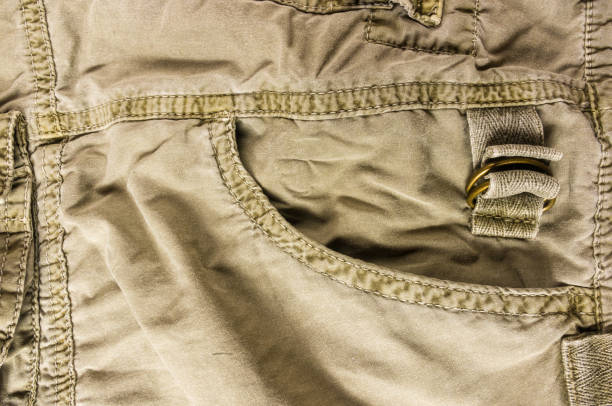 istock clothing items washed cotton fabric texture with seams, clasps, buttons and rivets 1073365430