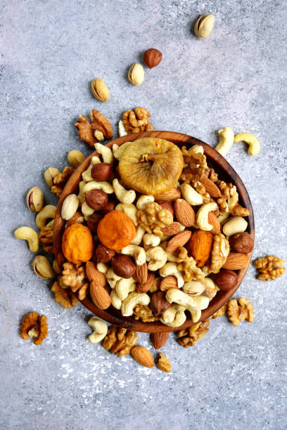istock Wooden bowl with nuts ( pistachio, walnut, hazelnut, cashew, almond) 1073366762