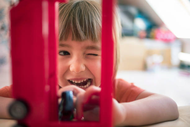 Cute child playing with toys at home.