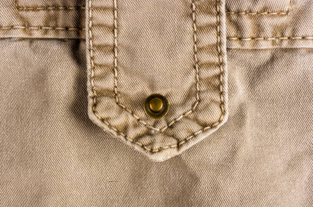 istock clothing items washed cotton fabric texture with seams, clasps, buttons and rivets 1073366844