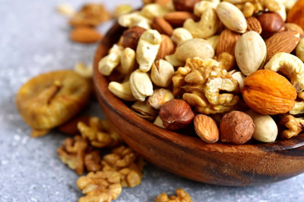 istock Wooden bowl with nuts ( pistachio, walnut, hazelnut, cashew, almond) 1073366918
