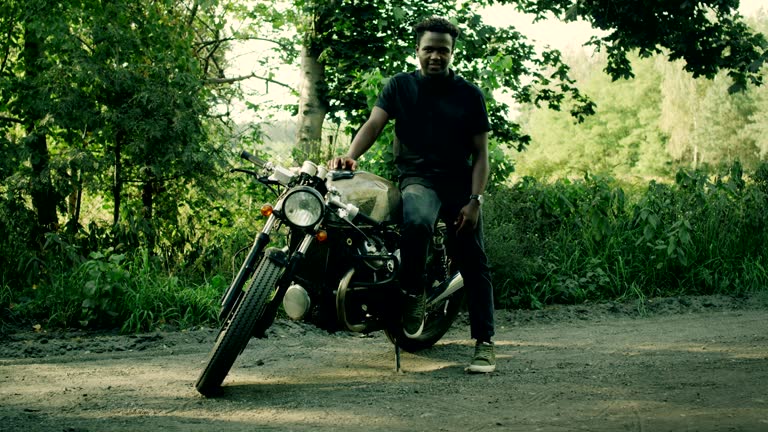 African ethnicity man and his machine. Custom motorcycle