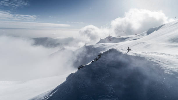 istock Snowboarder on the summit Snowboarder on mountain top 1073370354