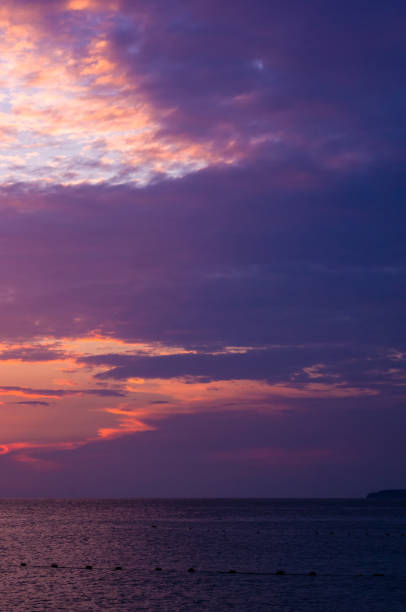 istock Amazing sea sunset on the pebble beach, the sun, waves, clouds 1073370418