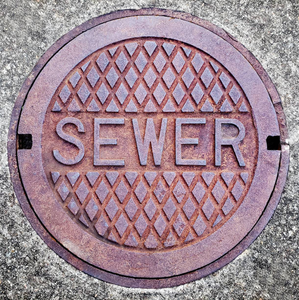 Sewage Manhole Sewer Cap - Steel Metal Lid Sewage Manhole Sewer Cap - Steel Metal Lid Typescript sewer lid stock pictures, royalty-free photos & images