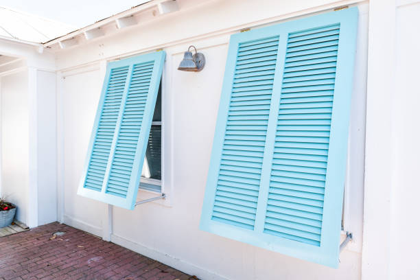 pastel turquoise blue colorful hurricane window shutters closeup architecture open exterior of house in florida beach home during sunny day, painted - house residential structure two objects building exterior imagens e fotografias de stock