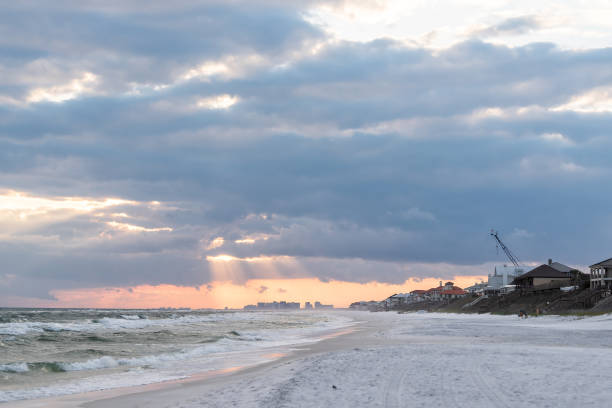 istock Dramatic magical light sunset with sun god rays in Santa Rosa Beach, Florida with Pensacola coastline coast cityscape skyline in panhandle, ocean gulf mexico waves 1073386664