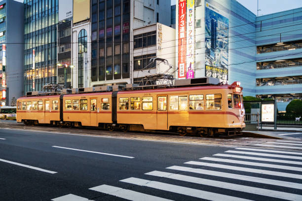 Hiroshima, Japan, November 26th 2018: Downtown Hiroshima City Street at twilight with the famous illuminated Hiroshima Tram - Streetcar. Hiroshima, Honshu, Japan, Asia.