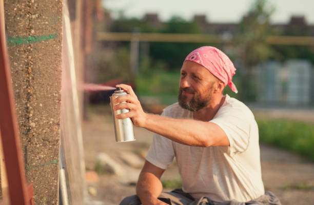 istock young man spray paint artist 1073391220