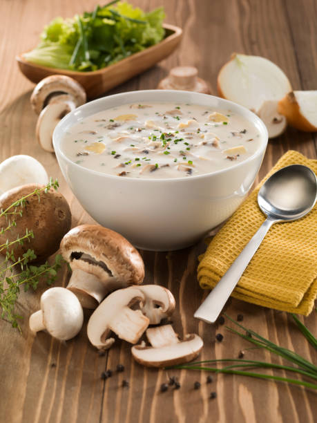 istock Cream soup with mushrooms on wooden table. 1073399328
