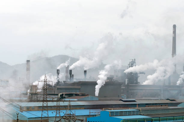 istock Smoking chimneys of a factory 1073402246
