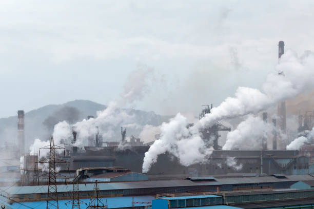 istock Smoking chimneys of a factory 1073402328