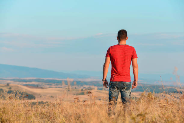 istock Handsome man walking in the countryside. 1073402460